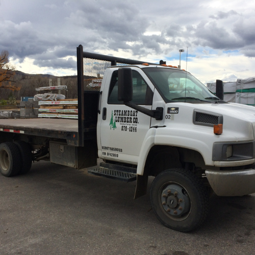 A white flatbed truck with 