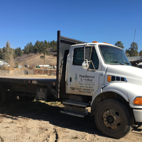 A white flatbed truck with 