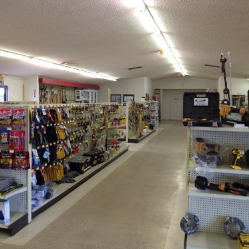 A well-lit hardware store interior with neatly organized shelves displaying tools, accessories, and equipment, creating a tidy and inviting atmosphere.