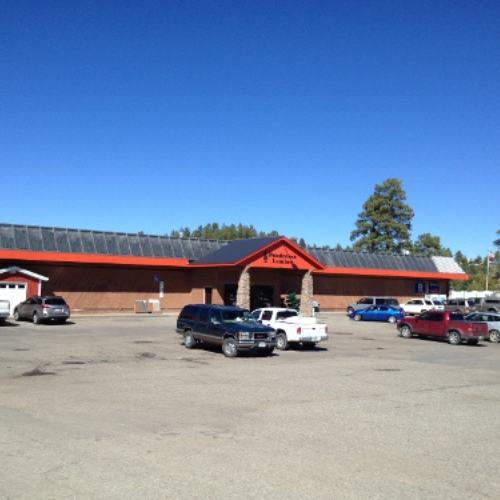 A one-story brick building with a red roof, labeled 