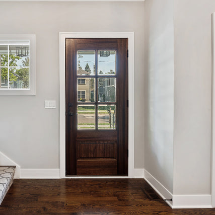 Interior & Exterior DoorsA wooden front door with glass panels shows a clear view of a suburban street. Sunlight brightens the room, highlighting light gray walls and dark wood flooring.